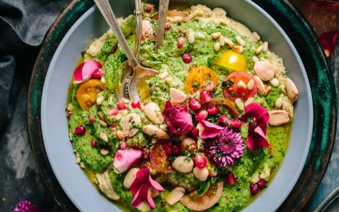 mixed dips with colorful and healthy toppings sprinkled with nuts viewed from above